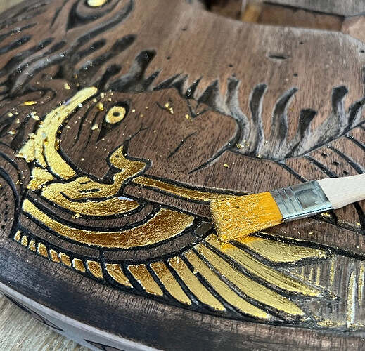 Close-up of the hand-carved relief finished in gold leaf