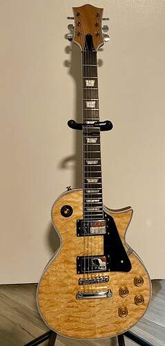 Finished LP-style DIY guitar build with a natural quilted maple veneer top, chrome hardware and pearl inlays