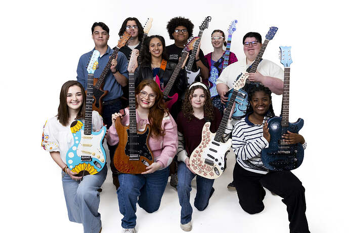 The ten builders of SAU's guitar building class with their finished guitars